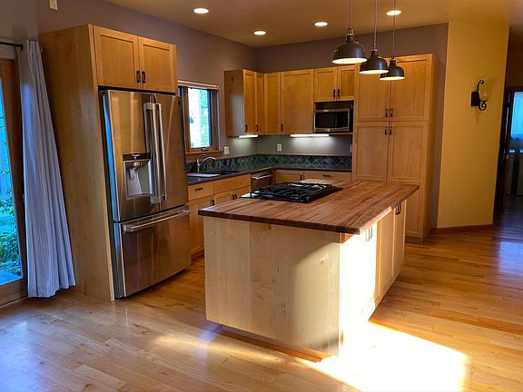 Kitchen with gas stovetop, large fridge, and tons of storage