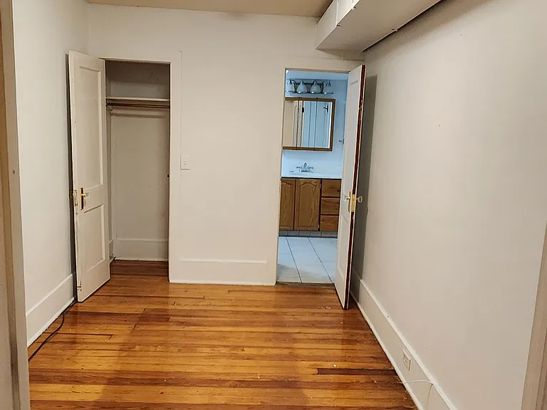 2nd bedroom looking at closet and bathroom door from entrance door.