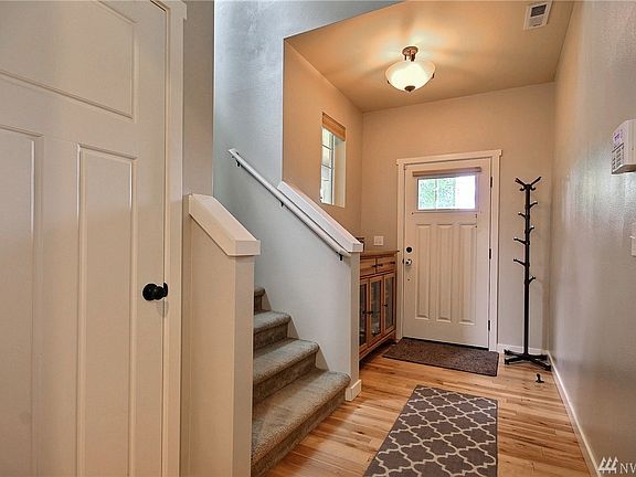 Beautiful millwork & hardwood floors & vaulted ceilings make this entry inviting.