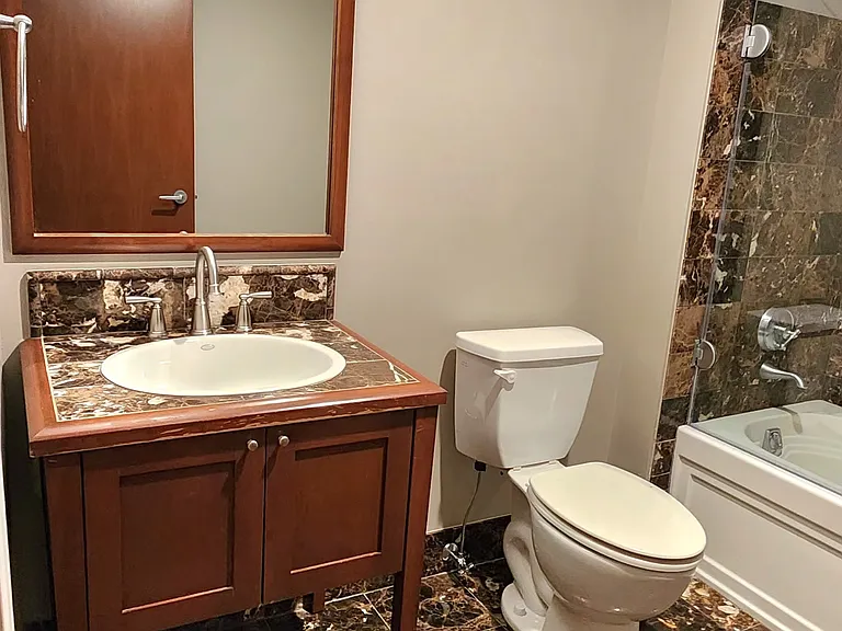 View from bathroom door entry toward sink and toilet.