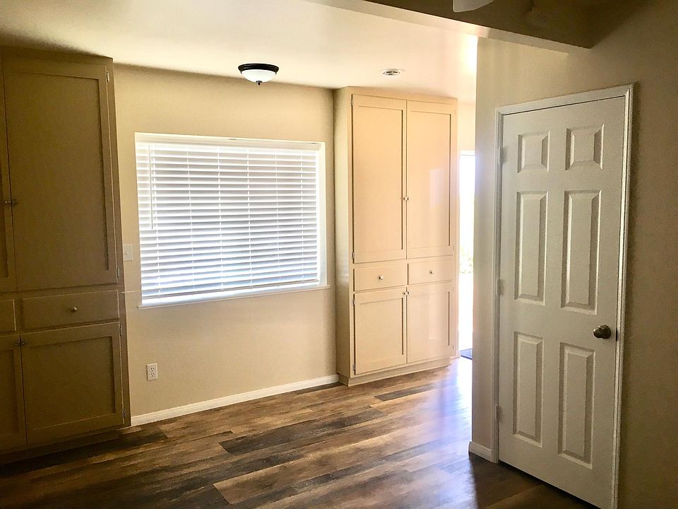 Taken from the living room, showing coat closet and tall storage cabinets.