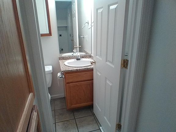 half bath, next to laundry hook ups, enterance to garage