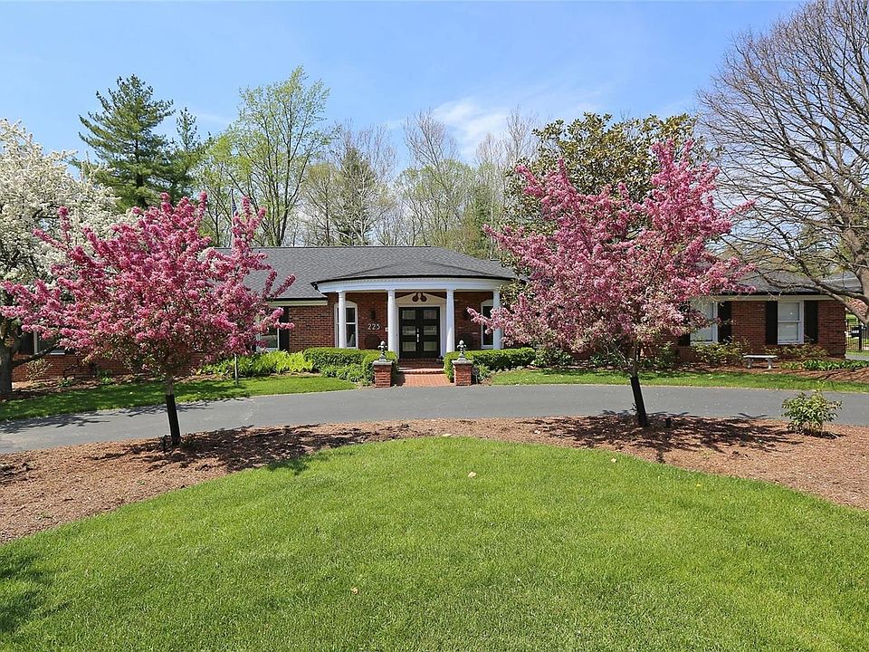 Lovely circle drive with beautiful flowering trees.