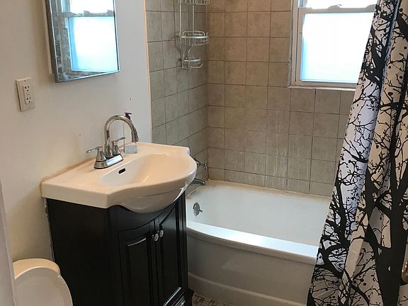 Full bath with ceramic tile floors, new vanity