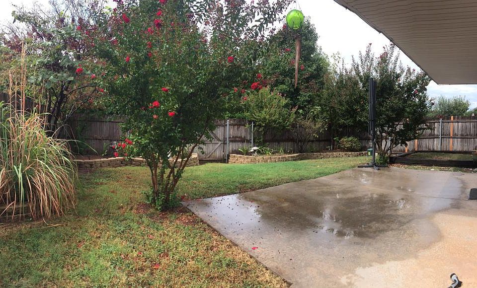 Enjoy your private oasis with a small fenced backyard featuring a charming raised veggie garden.