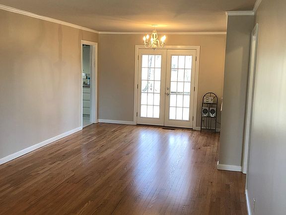 Living room to dining room area. French doors to back deck. Entrance to kitchen on the left.