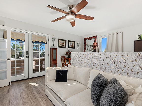 Studio/guest room living space with French doors to patio