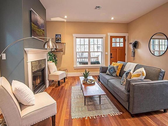 Living room has lots of natural light and a pull-out queen sofa.
