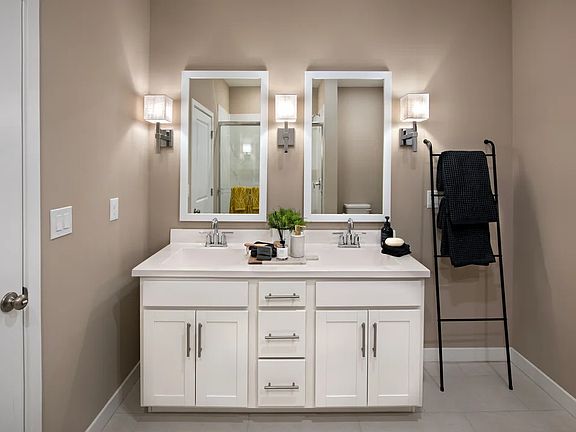 Primary bath with dual white-framed mirrors