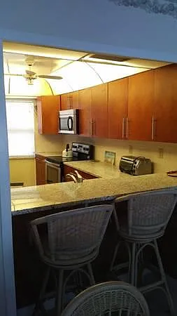 Kitchen open to dining and living area with view of Gulf