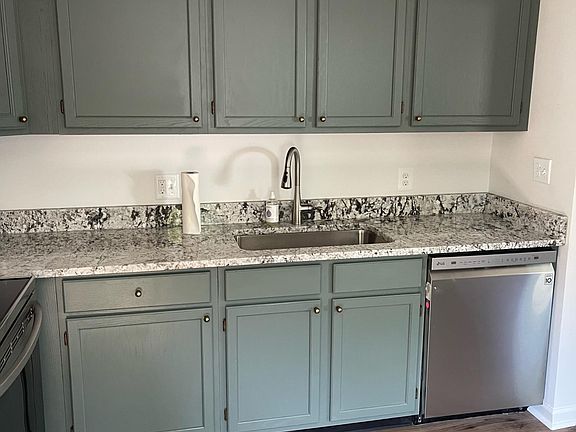 Brand new kitchen with stainless steel appliances and granite countertops