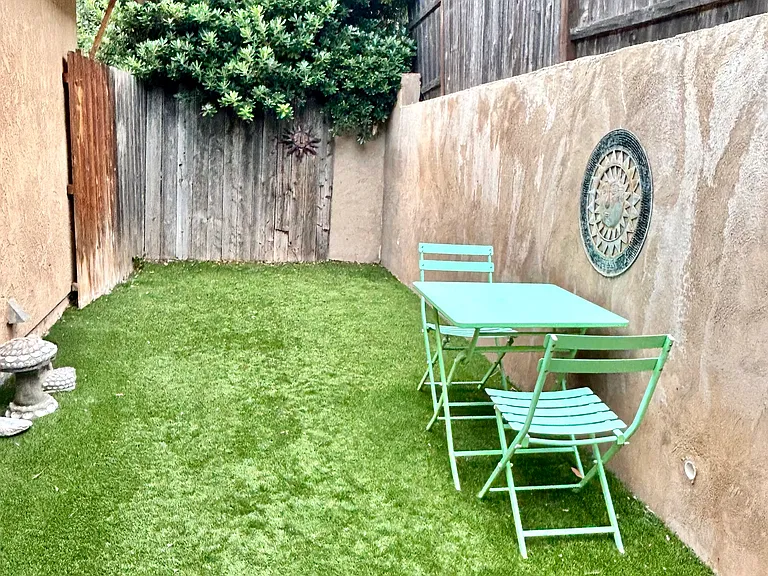 fenced-in backyard with outdoor seating
