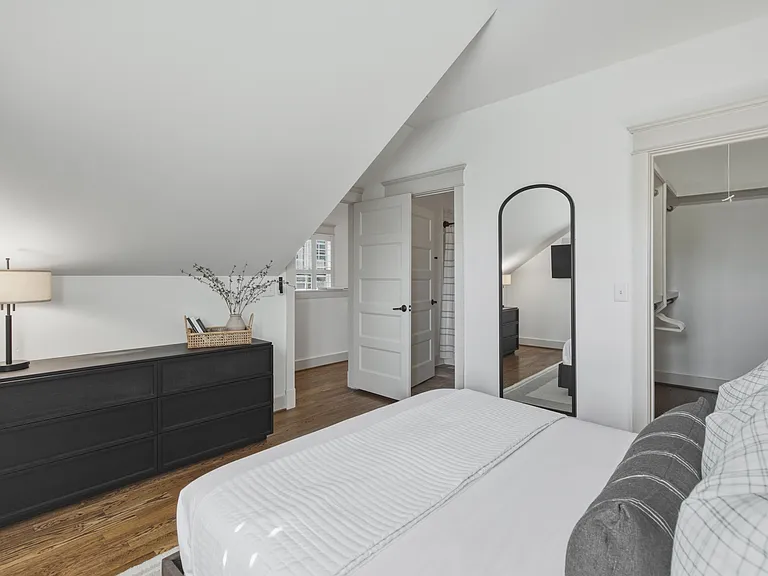 Find a comfortable queen bed in bedroom 3, along with a walk-in closet, dresser, smart TV, and ceiling fan.