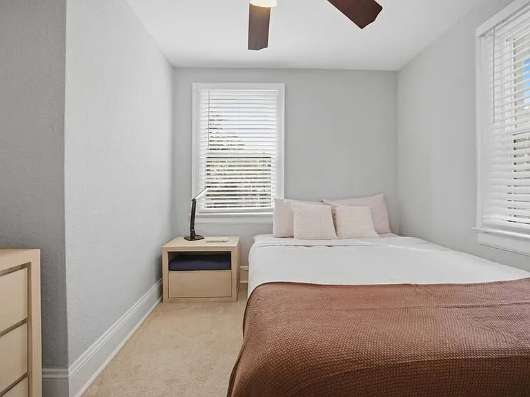 Bedroom 4: A cozy, quiet spot with a queen size bed for a great night's sleep.