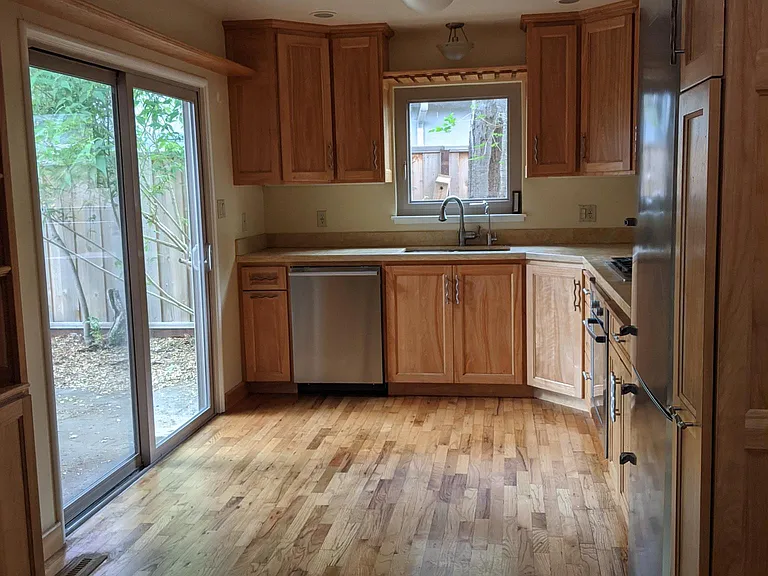 Kitchen has updated appliances and custom cabinetry.