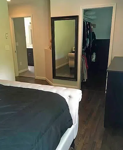 View of primary bedroom looking into large walk in closet and bathroom