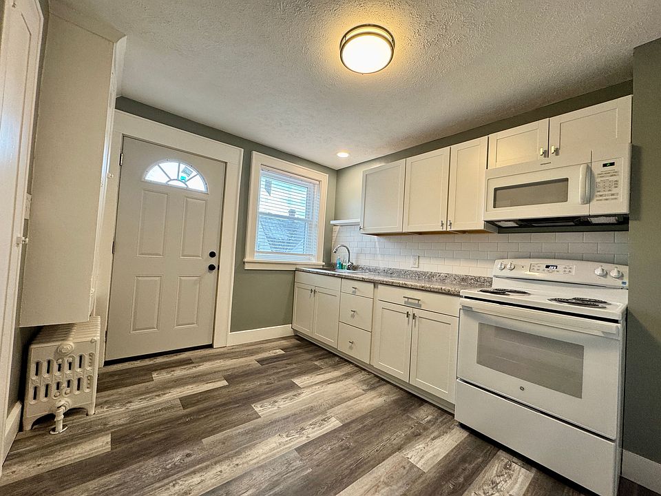 All new cabinets and appliances. Door for back stairwell access.