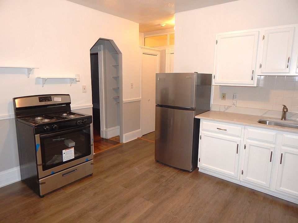 Kitchen with stainless gas stove and refrigerator