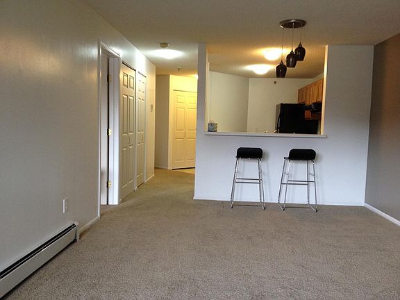 Spacious living room/dining area, leading to kitchen.