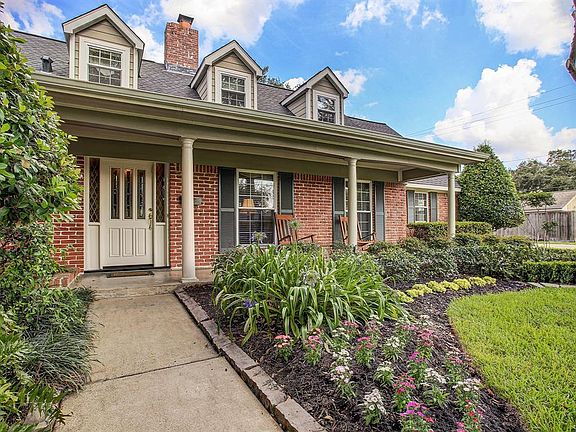 Front Porch: Columns, leaded glass front door, Arts and Crafts color scheme. Note refined landscaping.