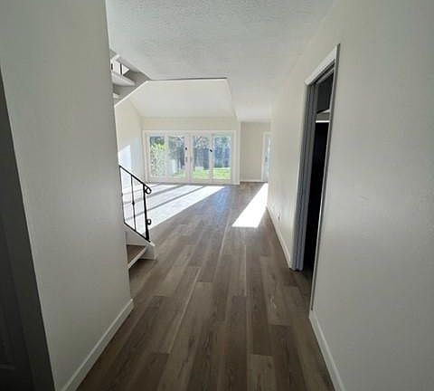 entrance that looks to living area and new sliding door system that opens onto green belt