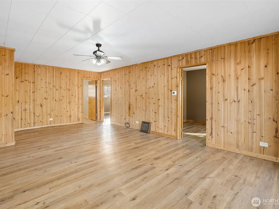 Living space with access into two bedrooms and office.>
