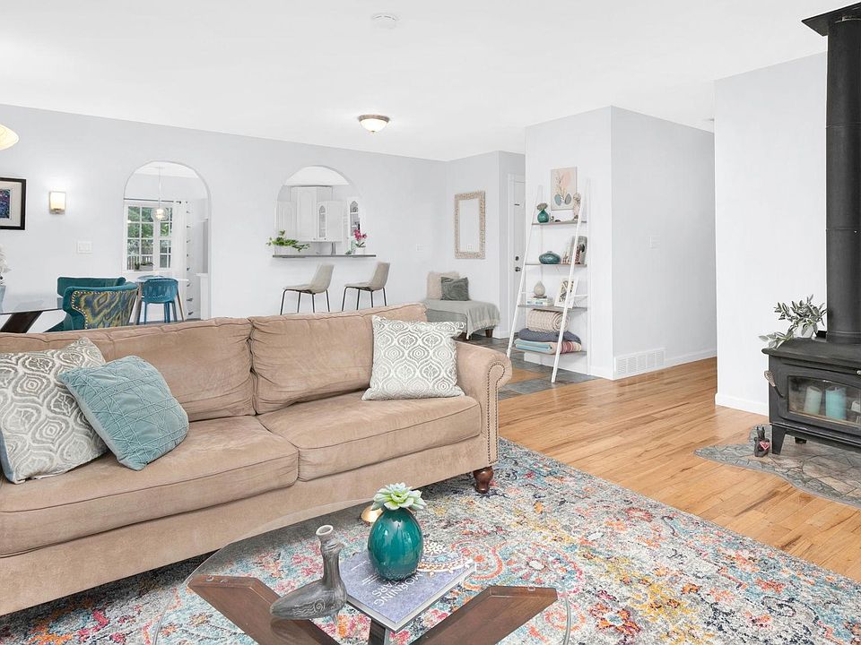 Open floor plan with living room, dining room, and pass through access to the kitchen with bar seating area