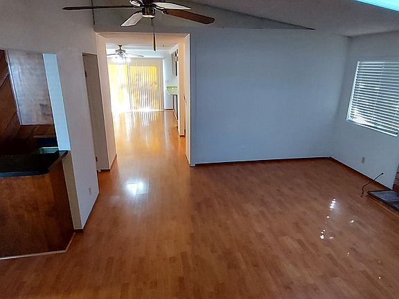Living room (left to right: access to bonus room, hallway, and family room)