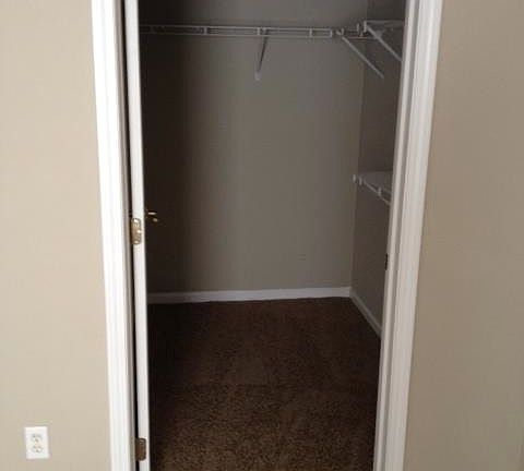 Master bedroom walk-in closet with custom organizers