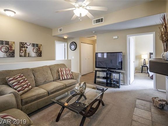 Living Room with TV. Guest Room to the Right. Washer & Dryer behind Closet Doors. Stair Case is behind Couch.