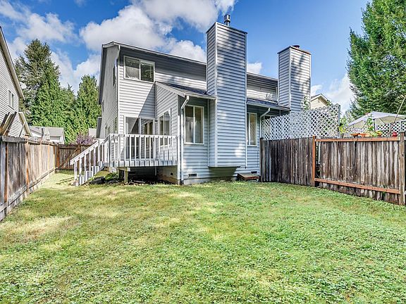 Starting outside, the back yard features a private deck for BBQs and lush grassy yard.