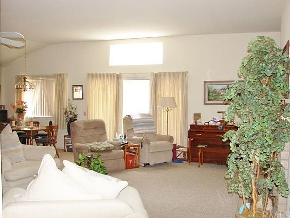 ENTRY OPENS TO GREAT ROOM/LIVING ROOM AREA WITH DRAMATIC VOLUME CEILINGS. PLENTY OF SEATING AND FURNITURE PLACEMENT OPTIONS. LIVING ROOM OPENS TO BACKYARD COVERED PATIO FOR MORE ENTERTAINING OPTIONS