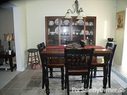 Dining Room : Tile floor, adjoining deck to the right, open to living room on left. (11 x 11)