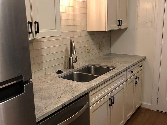New kitchen with granite counters and subway tile back splash.