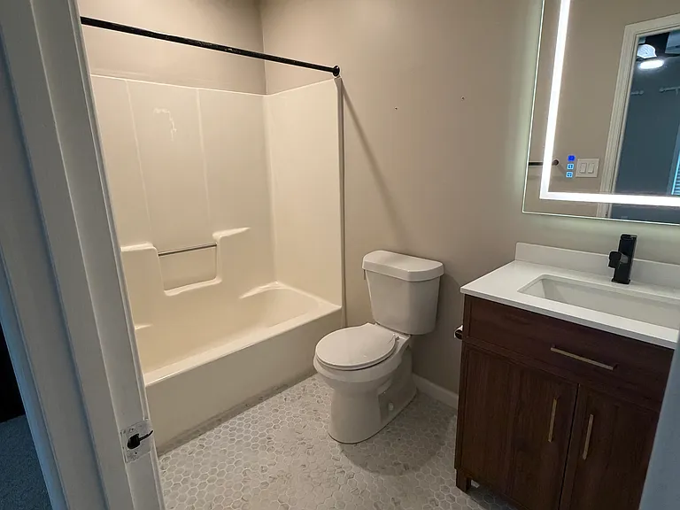 Front Bedroom's Bathroom with a tub