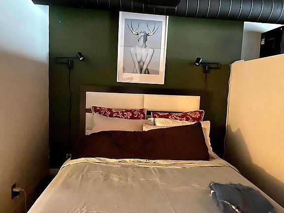Bedroom; easily fits queen mattress with bed frame.