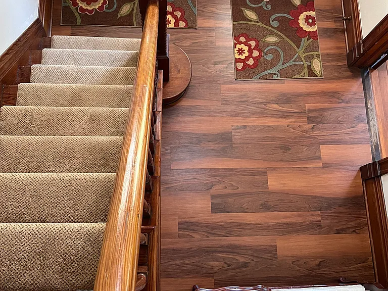 New carpet on stairs and luxury vinyl laminate in foyer.