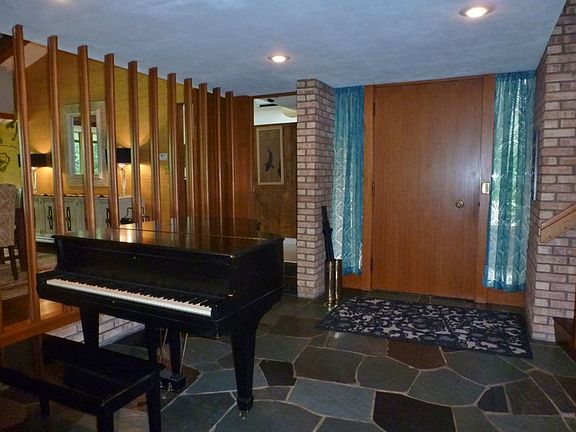 The large entry with slate floors currently houses a Steinway baby grand piano!