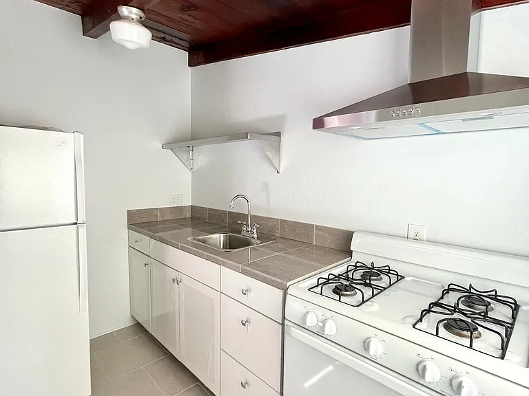 Kitchen - Marble-tiled counters, gas range, new hood vent.