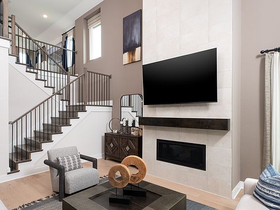 A modern and stylish living room with a large TV mounted on the wall, a sleek black coffee table, an