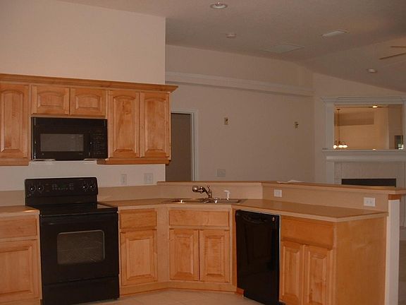 Kitchen has black appliances.