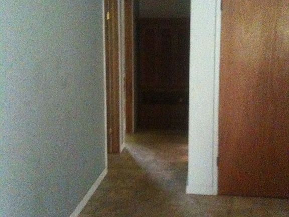 Hallway view to the 2 bedrooms,a full bath, coat closet in living room. 