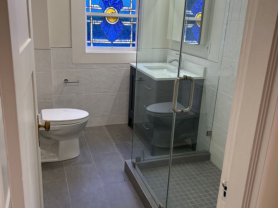 Stunning bathroom- with a beautiful stained glass window- all brand new- large glassed in shower, medicine cabinet with mirror, vanity light- separate from overhead lights, fan and spectacular designer tile