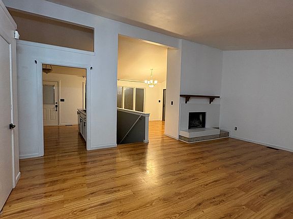 Entrance leads straight to living room area. You can also see stairway going to basement