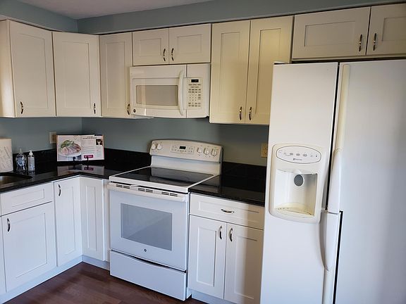 Lovely updated kitchen with granite counters, classic white appliances and enough space to put a small bistro table and chairs, for an eat-in kitchen. Kitchen features electric cooking stove, built-in microwave, ice-maker refrigerator, dishwasher, dispos