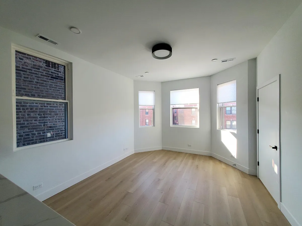 Spacious and bright living room with large windows - 3244 W Diversey Ave #3