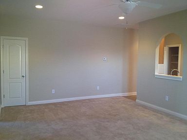 Family room with decorative cut-out to open kitchen