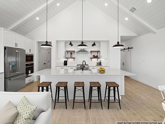 Kitchen with vaulted ceiling, island pendant lighting
