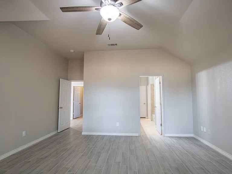 Back of master bedroom looking toward the master bathroom entrance on the right hand door