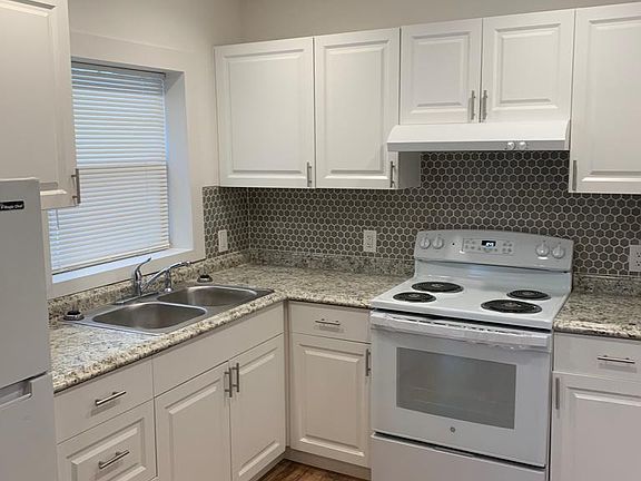 Comfortable, well-lit kitchen with a fridge and essential amenities. Lakeland, FL